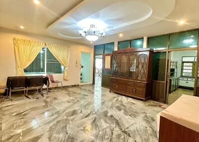 Spacious living room with marble flooring and modern lighting