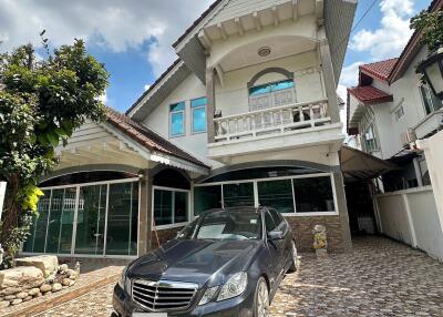 Exterior view of a residential property with a car parked in the driveway.