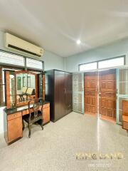 Bedroom with vanity, wardrobe, air conditioner, and large wooden doors