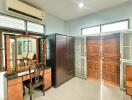 Bedroom with vanity, wardrobe, air conditioner, and large wooden doors