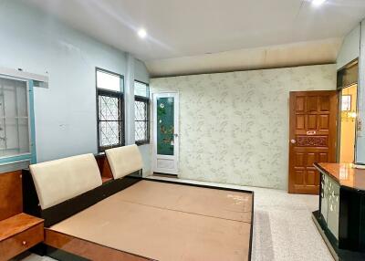 Bedroom with wooden bed frame and decorative walls