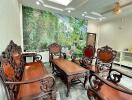 A well-furnished living room with ornate wooden furniture and a large wall mural.