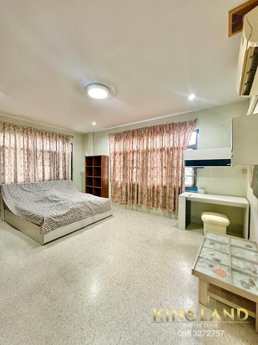 Spacious bedroom with bed, shelves, desk and air conditioning