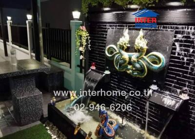 Outdoor area with water feature and seating