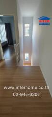 Upstairs hallway with natural light from small windows