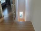 Upstairs hallway with natural light from small windows