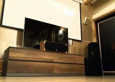 Living room with entertainment center and piano