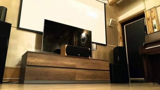 Living room with entertainment center and piano