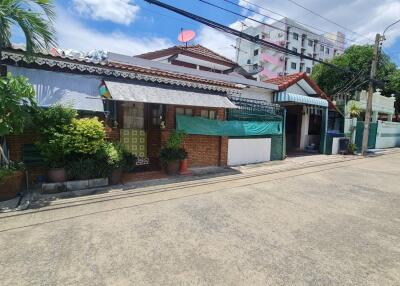 Street view of houses with plants and cars