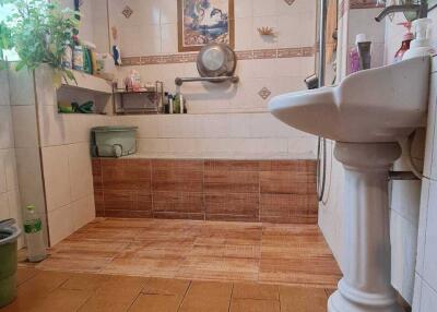 Bathroom with tiled flooring and wall shelving