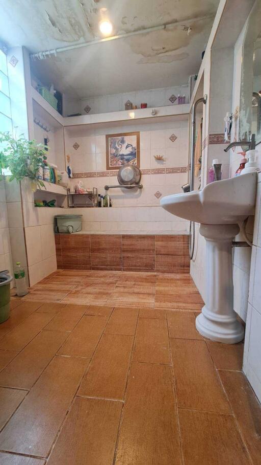 Bathroom with tiled flooring and wall shelving