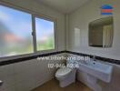 Bathroom with sink, toilet, and window