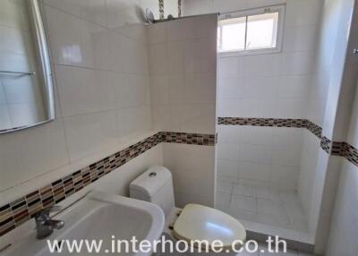 Modern bathroom with sink, toilet, and shower area