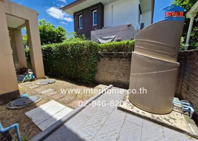 Outdoor area with greenery and water tank