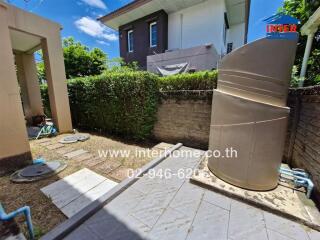 Outdoor area with greenery and water tank