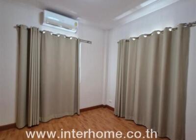 Empty bedroom with curtains and air conditioner