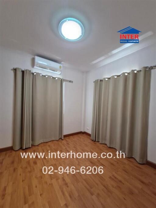 Empty bedroom with curtains and air conditioner