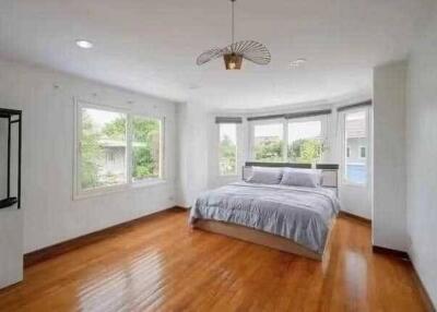 Spacious bedroom with large windows and a double bed