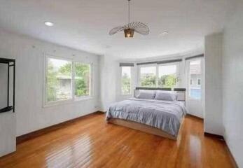 Spacious bedroom with large windows and a double bed