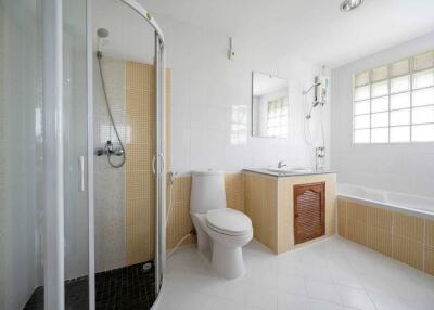 Modern bathroom with shower, toilet, bathtub, and sink