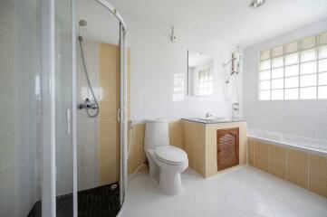 Modern bathroom with shower, toilet, bathtub, and sink