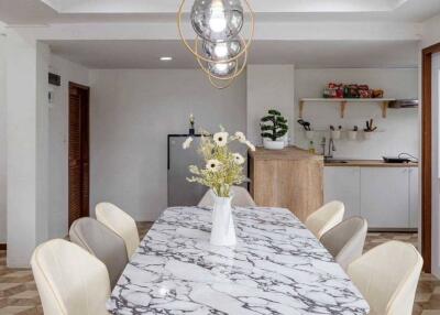 Modern dining room with marble table and chandelier