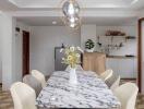 Modern dining room with marble table and chandelier