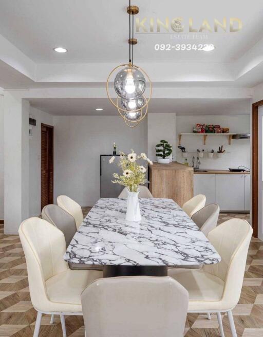 Modern dining room with marble table and chandelier