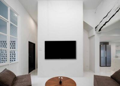 Modern living room with mounted TV and minimalist decor