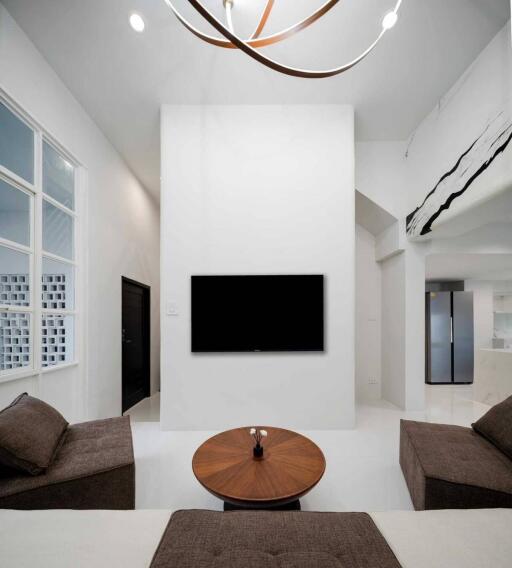 Modern living room with mounted TV and minimalist decor