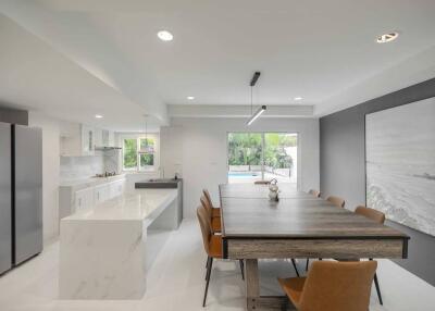 Modern kitchen and dining area with large table and exterior view