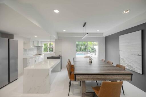 Modern kitchen and dining area with large table and exterior view