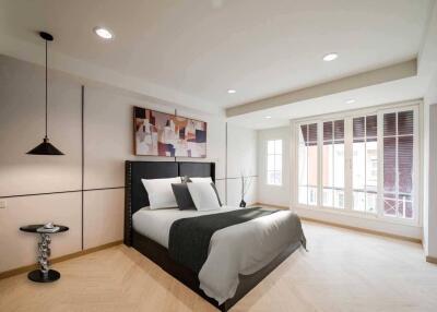 Modern bedroom with large windows and natural light