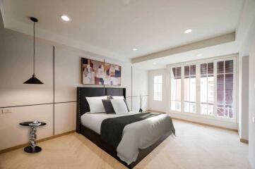 Modern bedroom with large windows and natural light