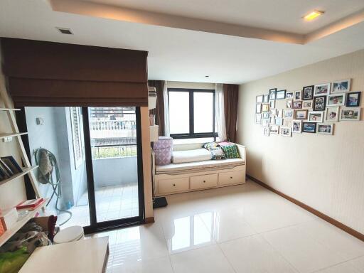 Bright bedroom with bed, large windows, and balcony