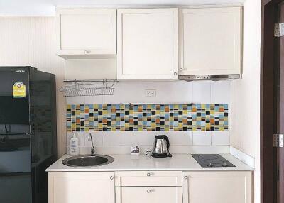 Modern kitchen with tiled backsplash and appliances