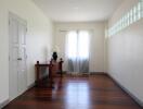 Minimalist bedroom with wooden floors