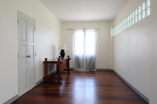 Minimalist bedroom with wooden floors