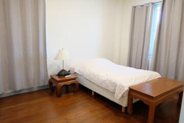 Bedroom with single bed and wooden furniture