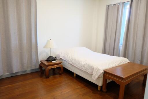 Bedroom with single bed and wooden furniture