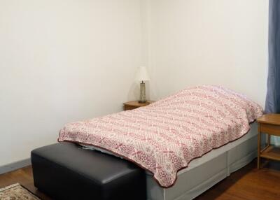 Cozy bedroom with single bed and wooden flooring