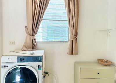 Laundry room with washing machine and storage drawer