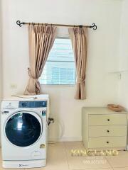 Laundry room with washing machine and storage drawer