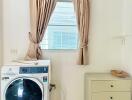 Laundry room with washing machine and storage drawer