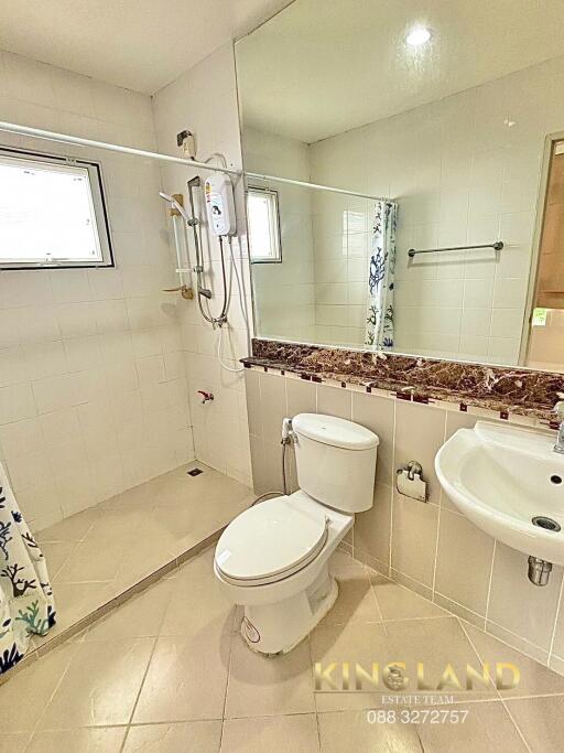 Clean and modern bathroom with shower, toilet, and sink