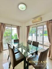 Dining room with glass table and six chairs