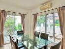 Dining room with glass table and six chairs