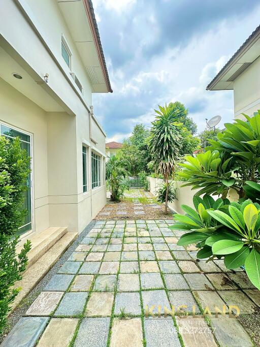 Exterior view of a building entryway with garden