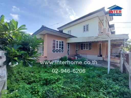 Two-story house with green yard