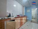 Kitchen with tiled countertops and bottles on the counter